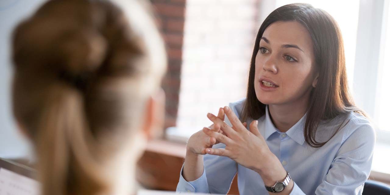 A woman mentoring others in an office